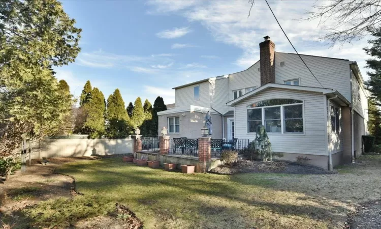 Rear view of house featuring a lawn