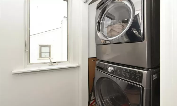 Laundry area featuring stacked washer and clothes dryer