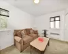 Carpeted living room featuring a wealth of natural light and radiator heating unit