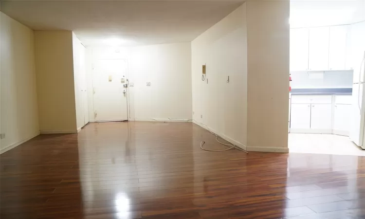 Spare room with dark hardwood / wood-style floors