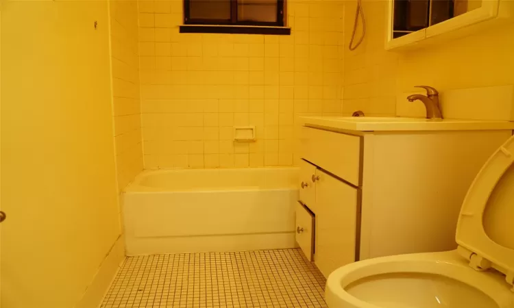 Bathroom featuring tile patterned floors, vanity, and toilet