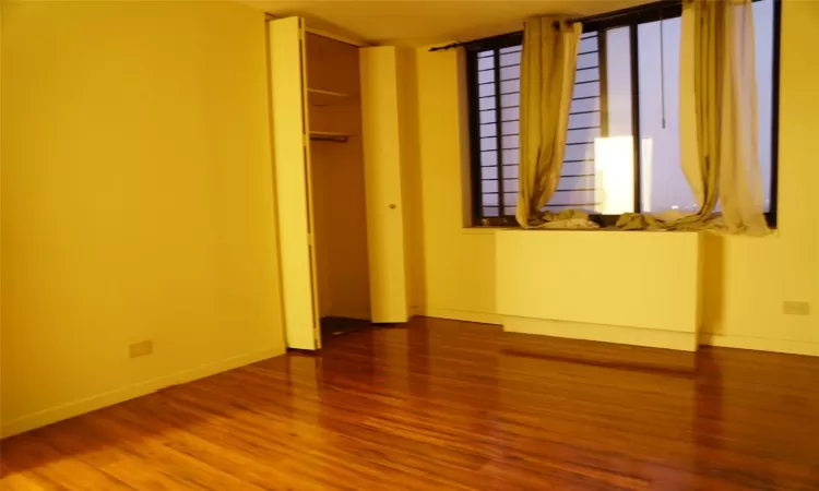 Unfurnished bedroom featuring a closet and hardwood / wood-style floors