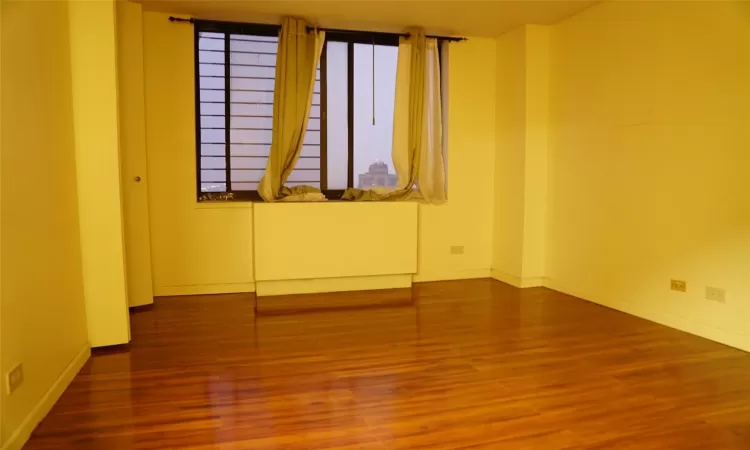 Empty room featuring hardwood / wood-style flooring