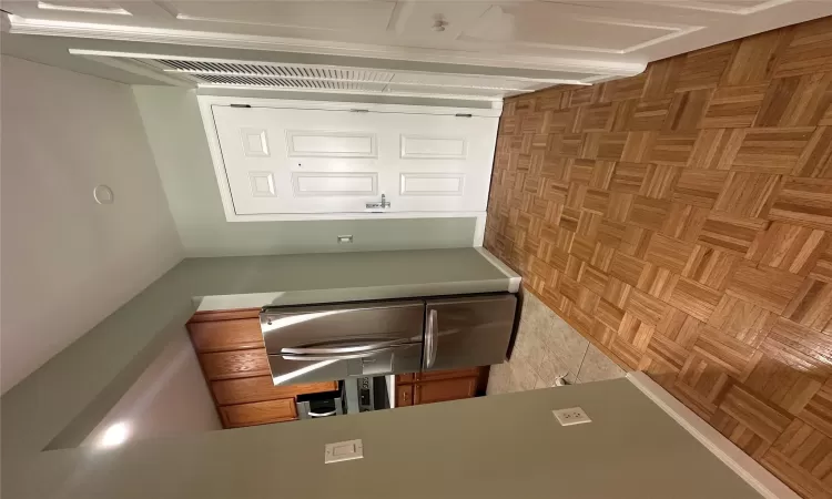 Kitchen featuring light parquet flooring and fridge