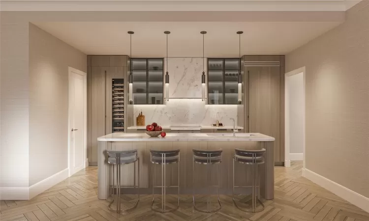 Kitchen with decorative light fixtures, light parquet floors, and a center island with sink