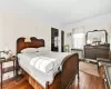 Bedroom featuring radiator and dark hardwood / wood-style floors