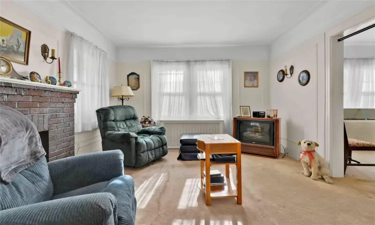 Carpeted living room featuring a fireplace