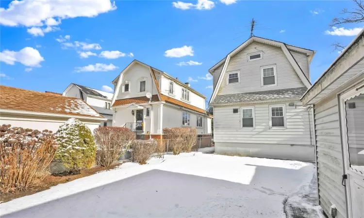 View of snow covered rear of property