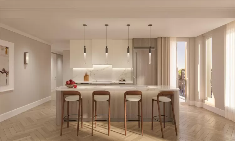 Kitchen with light parquet floors, a kitchen island with sink, a kitchen breakfast bar, decorative light fixtures, and white cabinets