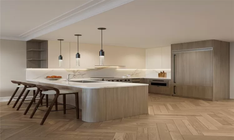 Kitchen with light parquet floors, pendant lighting, a kitchen bar, and kitchen peninsula