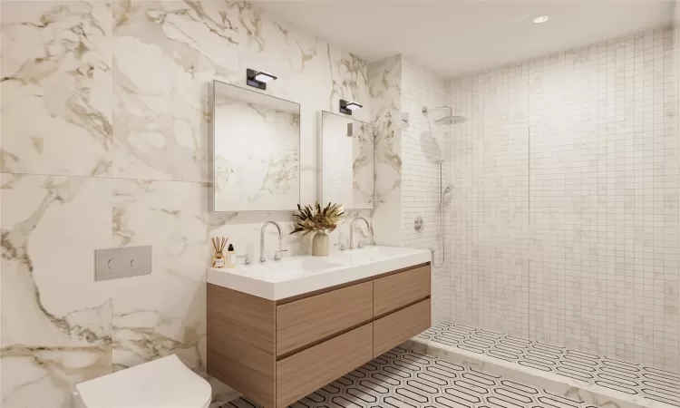 Bathroom featuring tile walls, toilet, vanity, and a tile shower