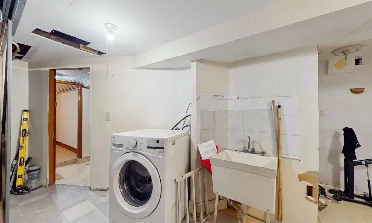 Laundry room featuring washer / clothes dryer and sink