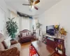 Living room with ceiling fan and wood-type flooring