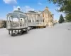 Snow covered property with a wooden deck and a gazebo