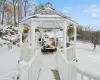 Snow covered deck featuring a gazebo