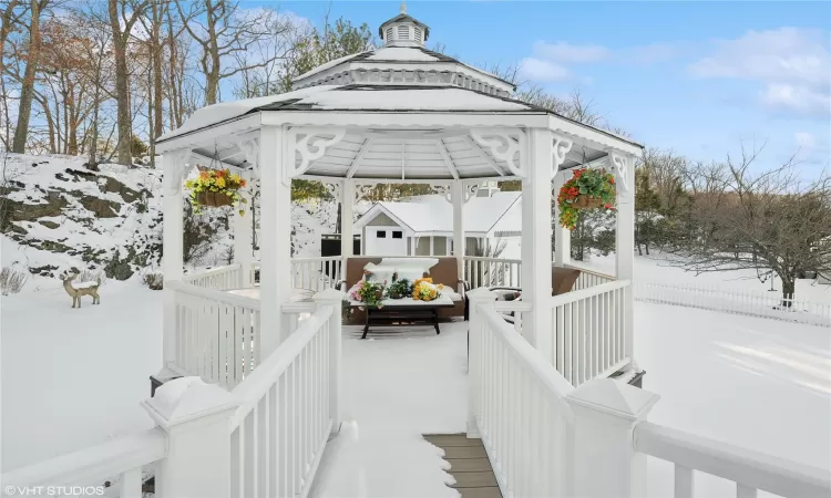 Snow covered deck featuring a gazebo