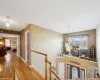 Corridor featuring hardwood / wood-style floors and an inviting chandelier