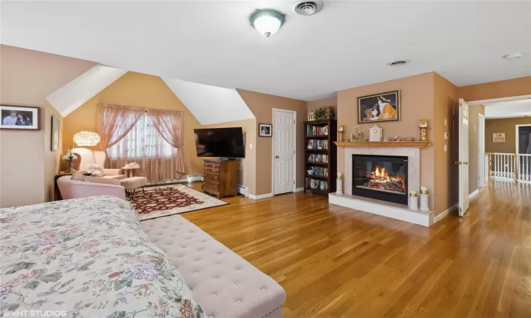 Bedroom with vaulted ceiling, sitting room and gas fireplace