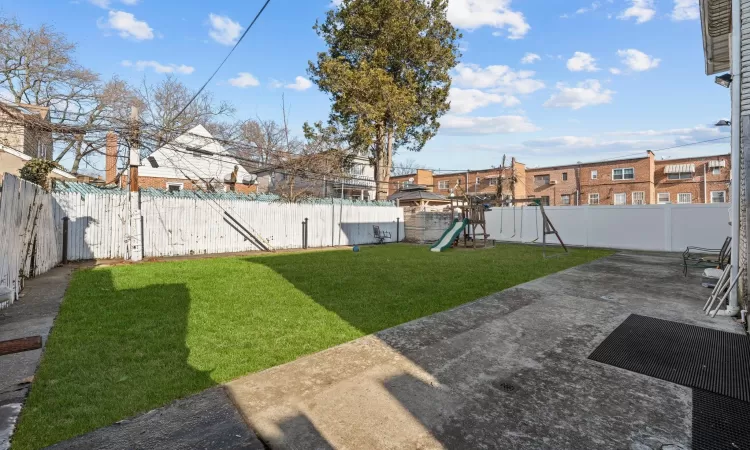 View of yard featuring a patio area and a playground