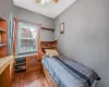 Bedroom featuring ceiling fan and dark hardwood / wood-style flooring