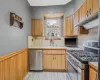 Kitchen with tasteful backsplash, sink, stainless steel appliances, and light hardwood / wood-style flooring