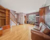 Living room with radiator, ornamental molding, and light hardwood / wood-style floors