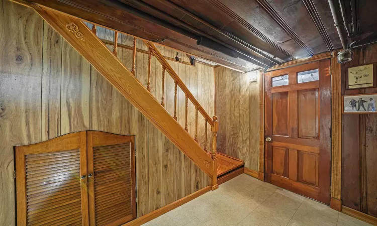 Basement featuring wood walls