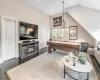 Recreation room with dark hardwood / wood-style flooring and lofted ceiling