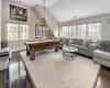 Playroom with lofted ceiling, billiards, and dark wood-type flooring