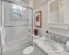 Full bathroom featuring bath / shower combo with glass door, toilet, and vanity