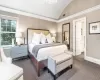 Carpeted bedroom featuring lofted ceiling and a notable chandelier