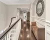 Hallway with dark hardwood / wood-style flooring and ornamental molding