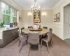 Dining space featuring ornamental molding and a chandelier