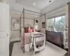 Bedroom featuring a tray ceiling, dark hardwood / wood-style floors, and ornamental molding