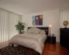 Bedroom with dark wood-type flooring