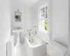 Bathroom featuring toilet, a tub to relax in, and sink