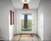 Doorway to outside with light wood-type flooring and baseboard heating