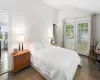 Bedroom featuring vaulted ceiling and dark hardwood / wood-style floors