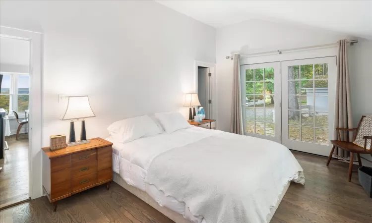 Bedroom featuring vaulted ceiling and dark hardwood / wood-style floors