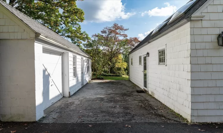 View of #77exterior featuring a garage and an outbuilding