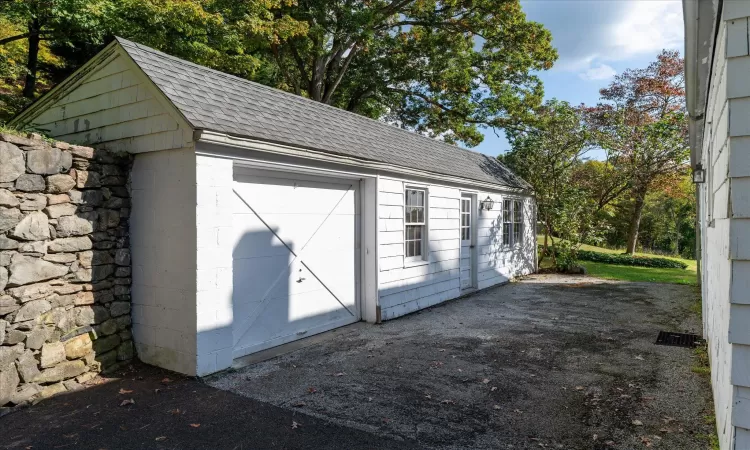 View of outbuilding with a garage