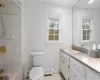 Bathroom with baseboard heating, a wealth of natural light, and tile patterned floors