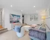 Living room featuring light carpet and a baseboard heating unit