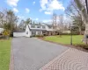 View of front of home featuring a front yard, a garage, and an outbuilding