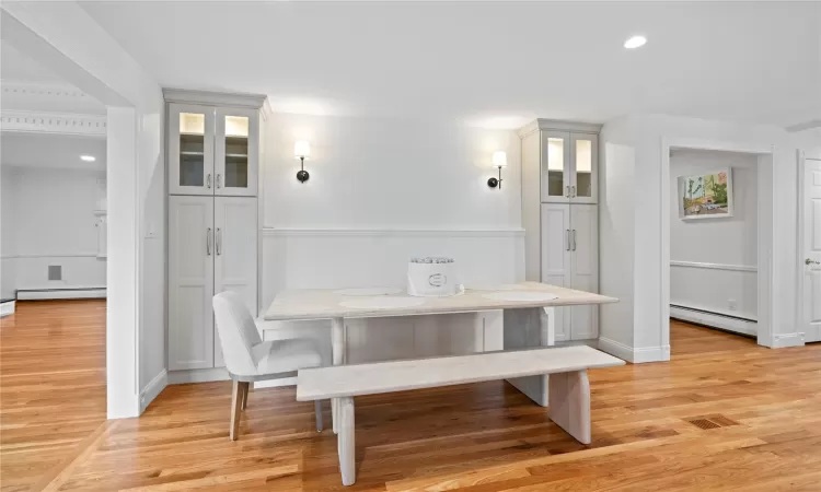 Dining room featuring light hardwood / wood-style floors, breakfast area, and a baseboard heating unit