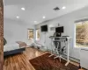 Bedroom with crown molding, hardwood / wood-style floors, and a baseboard radiator