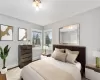 Bedroom featuring wood-type flooring and a baseboard radiator