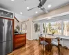 Dining room featuring ceiling fan, vaulted ceiling, a wealth of natural light, and light hardwood / wood-style flooring