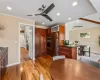 Kitchen with ceiling fan, appliances with stainless steel finishes, crown molding, and hardwood / wood-style flooring