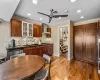 Kitchen featuring hardwood / wood-style flooring, stainless steel gas cooktop, dishwasher, wall chimney exhaust hood, and sink